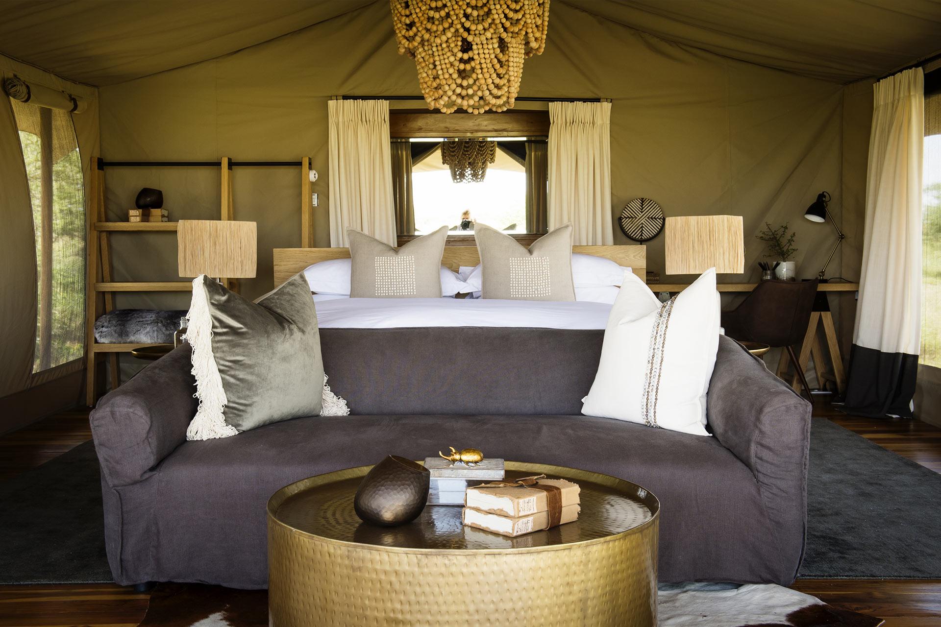 Serengeti Camp luxury tent Each tent sits atop a wooden platform raised 30 centimeters from the ground and has a generous sleeping area complete with lounge space. An ensuite bathroom with “his and hers” wash hand basins, large shower and proper flush toilet complete each guest tent